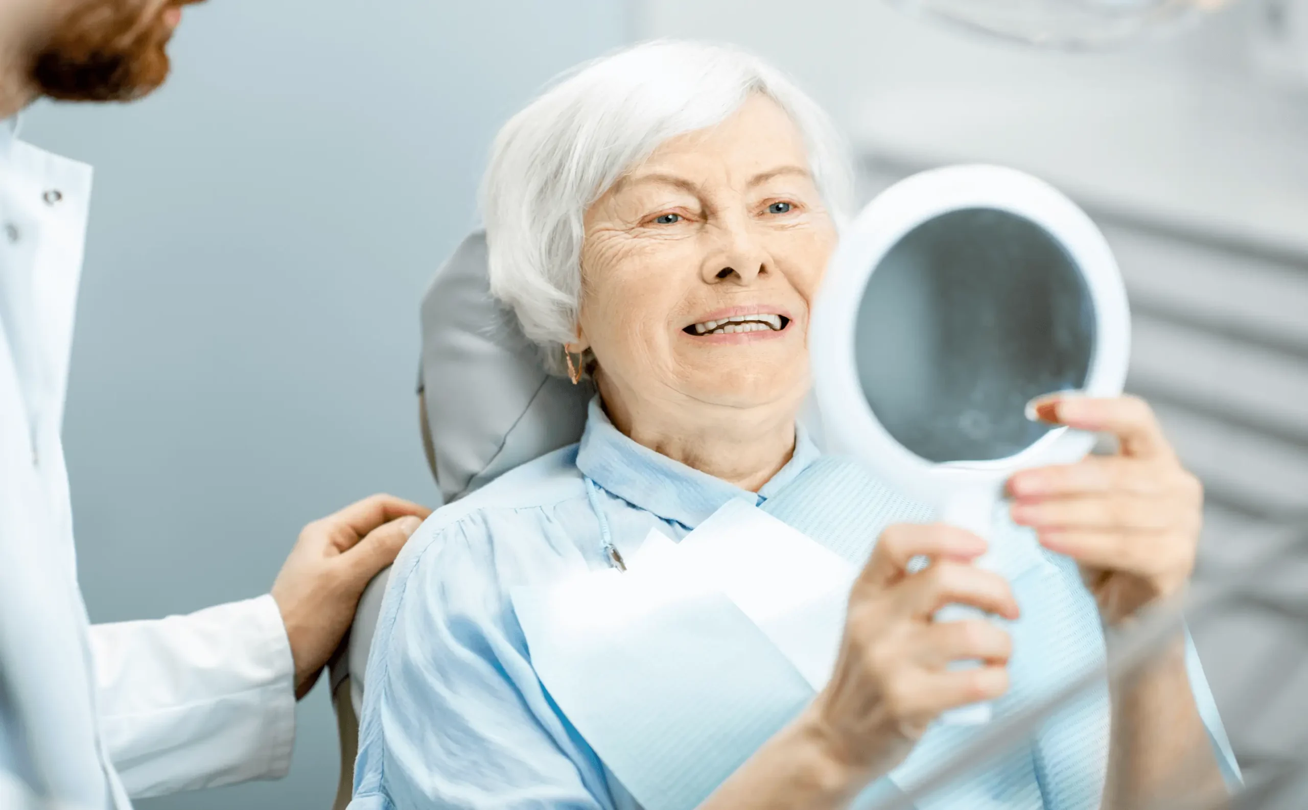 patient looking at their new smile after implants