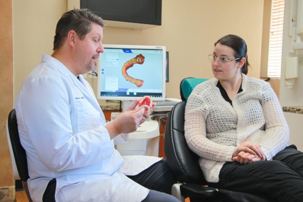 Dr. Saydyk walking a patient through their dental treatment